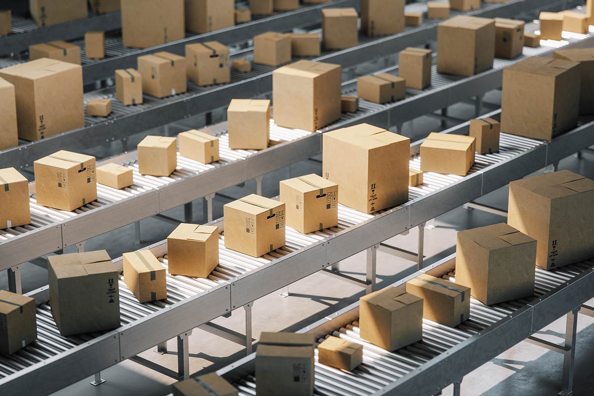 Corrugated folding cartons on a conveyer belt in a distribution center